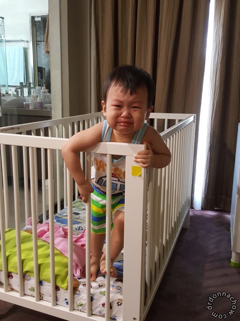 Trying to climb out of his bed