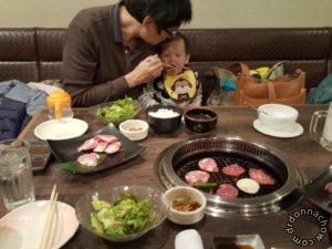 He had no baby chair to sit in this Japanese grill restaurant