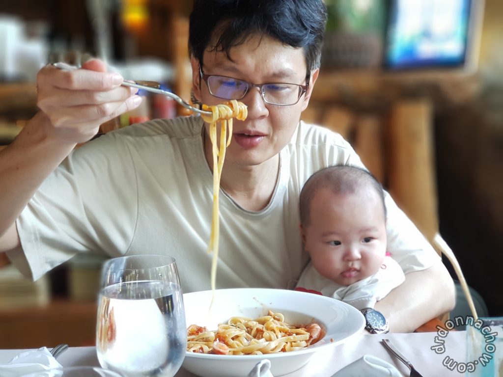 A busy dad eating his pasta